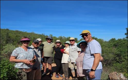 A group of people standing in a field

Description automatically generated